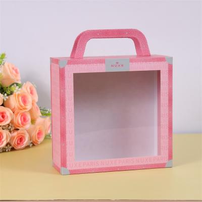 China Recyclable Luxury Pink Skincare Paper Box With Handle Cardboard Cosmetic Packaging Box for sale