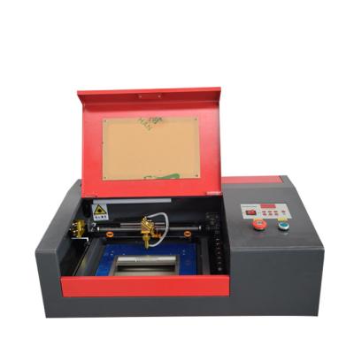 China Laser Engraving Nameplate Plastic Engraving Machine 40w 3020 4040 Laser Cutter CO2 Laser Cutter for sale