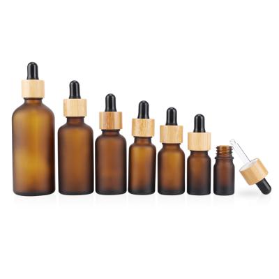 China Cosmetic factory direct essential oil bamboo bottle frosted amber glass dropper bottle with bamboo cap for sale