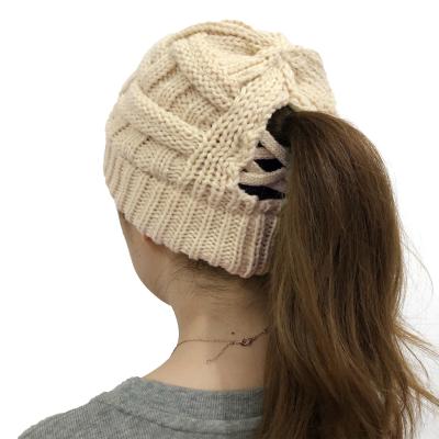 China JOINT Crisscross Acrylic Custom Knit Womens Leather Knit Ponytail Beanie Hat 2022 Women Chunky Warm Knitted Winter Crochet Hat for sale