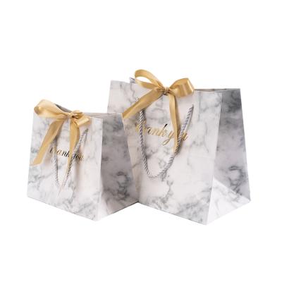 China Recyclable Wholesale Luxury Pink Cardboard Gift Paper Bags With Gold Ribbon And Rope for sale