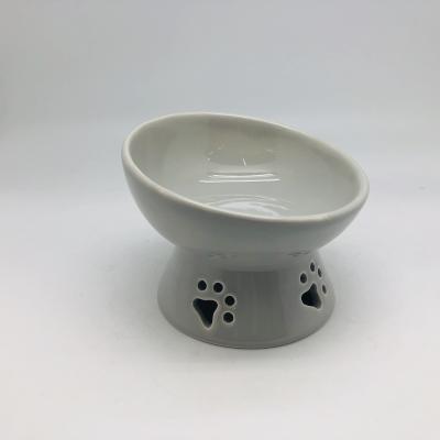 China Hot Selling Sustainable 15 Degree Tilted Ceramic Pet Bowl Hollow-Cut Out Paw Shape Custom Pet Bowl Cat Feeding Bowl for sale