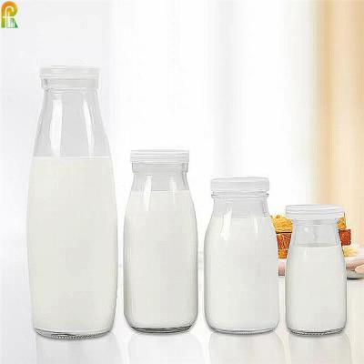 China Juice Packaging 100ml Vintage Milk Bottle Shaped Corked Glass Bottles for sale