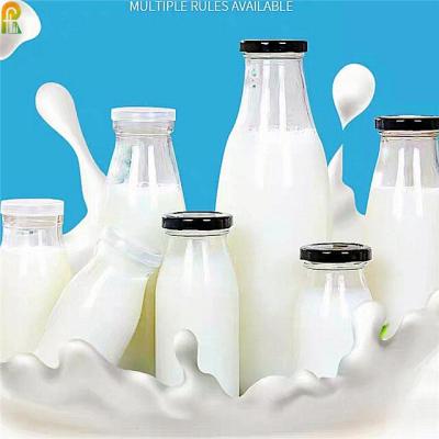 China Empty Juice Packaging 1000ml 500ml Clear Glass Round Milk Bottles With Lids Metal Juice Glass Bottles for sale