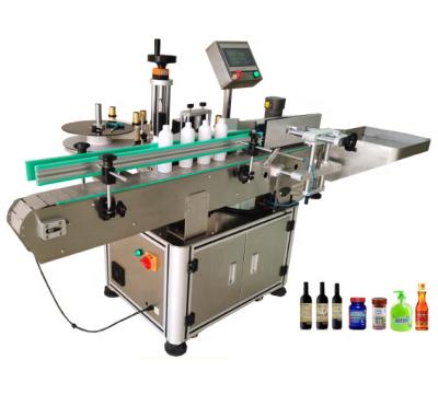 China food adhesive labeling machine for plastic bottles/round bottle labeling machine for sale