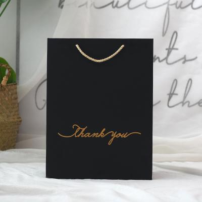 China Factory Wholesale Recyclable Cheap OEM Black Luxury Gift Kraft Paper Bag Custom Logo For Clothing Apparel Gift for sale