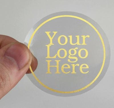 China Waterproof Customized Logo Printing Clear Gold Foil Stickers Transparent Label Waterproof Self Adhesive for sale