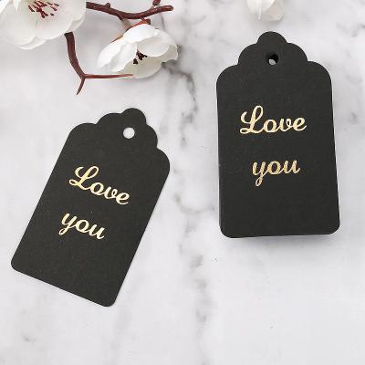 China Viable Custom Logo Black Fashion Swing Hang Tags Clothing Gold Foil Label Coated Paper Label Tags for sale