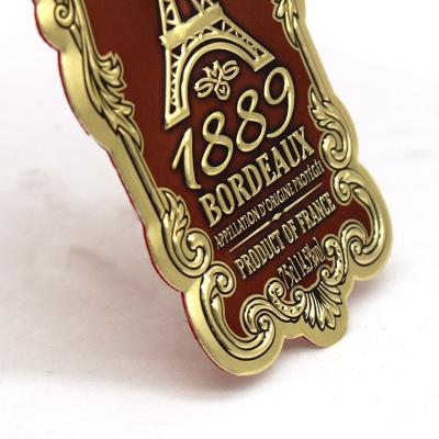 China Custom Made Metal Embossed Logo Wine Bottle Label Embossed Hot Stamping Badge for sale