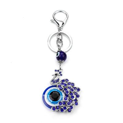 China Souvenir Gifts Promotion Fashion Accessories Evil Eye Peacock Crystal Rhinestone Keychain Key Rings For Gift for sale