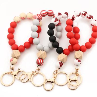 China Silicone Christmas Tree Wooden Beaded Moose Print Silicone Wristband Wood Beaded Bracelet Key Chain For Women Gift Buffalo Plaid Elastic Bracelet Key Chain for sale