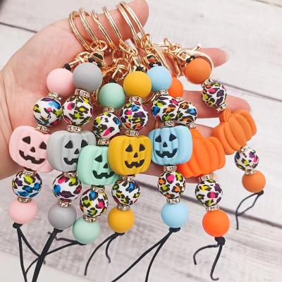 China Silicone Beads New Personalized Rhinestones Leopard Printing Silicone Beads Fashion Bag Pendant Cute Halloween Pumpkin Key Chain Keychain for sale