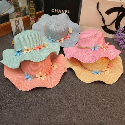 China Eco-Friendly Women Summer Sun Hat Garland Waved Floppy Sunshade Wide Brim Straw Hats Wholesale for sale