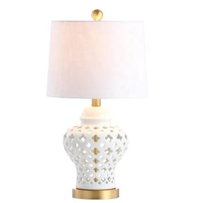 China Traditional fancy white hollow table lamp bedside china desk lamp ceramic decor for hotel bedroom and living room for sale