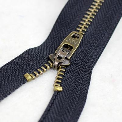 China 3# Durable Antique Brass Zipper With Spring Yg Jeans Slider Back Zipper for sale