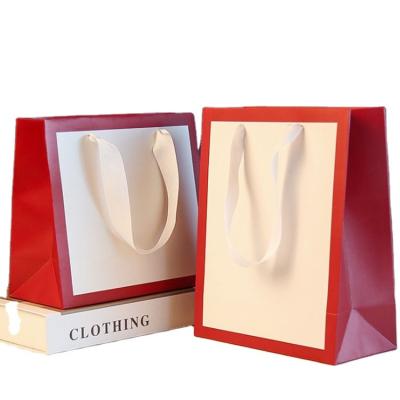 China Recycled Materials Paper bag custom logo corporate clothing gift bag wholesale advertising shopping white card packaging bag handbag custom for sale