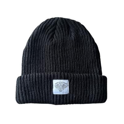 China PRIVATE LABEL Knitted Wool Winter Beanie Hat Black Woven Patch Skull Unisex Custom Woven Ribbed Skull Cap for sale