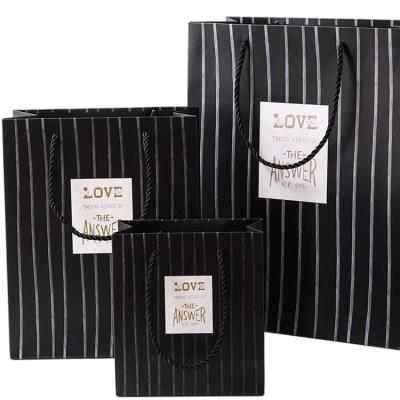 China Recycled Luxury Paper Gift Bags Newest Materials Custom Paper Gift Bags With Ribbon for sale