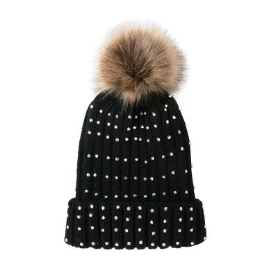 China COMMON Rhinestones Knit Acrylic Pom Pom Warm Beanie Hat For Women Winter Hat Raccoon Fur Custom Knitting Hats for sale