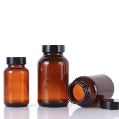 China 250ml 500ml 8oz 16oz Amber Clear Pharmaceutical Medical Capsule Home Decor Empty Wide Mouth Glass Pill Bottle With Lids for sale