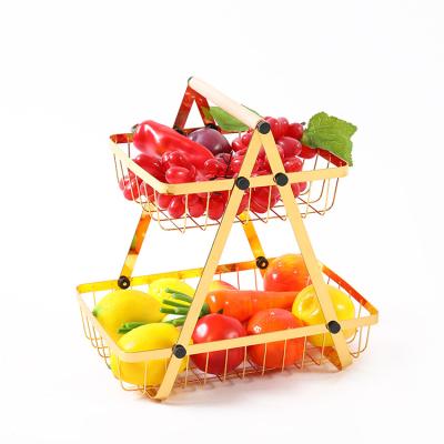 China Stocked 2 Tier Fruit Basket Kitchen Gold Metal Wire Vegetable Storage Baskets With Universal Wheel Balance Feet for sale