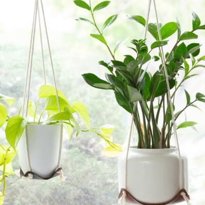 China Traditional Hanging Planter Baskets Flowerpot Plant Holder Macrame Plant Hanger Garden Leather Plant Hanger for sale