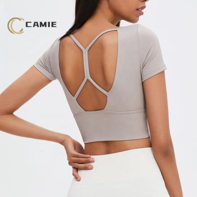 China CAMIE Antibacterial Sports Shockproof Yoga Tops Built In Popular Backless Fitness Gym Yoga Bra Tops Bra Tights For Women for sale