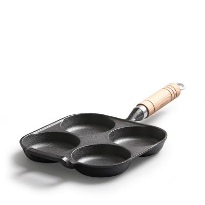 China Modern 4 Hole Restaurant Home Breakfast Cooking Egg Grill Pan Cast Iron Frying Pan with Wooden Handle for sale