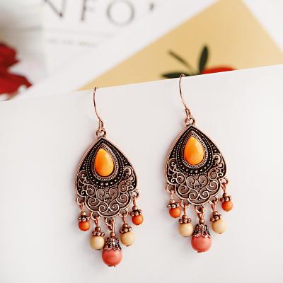 China BOHEMIA Bohemian Orange Beaded Tassel Drop Earrings Ethnic Cut Out Alloy For Women Vintage Stone Boho Ladies Earrings for sale