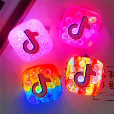 China 2022 waterproof silicone push bubble toss tiktok pop it up coin purses toddler tiktok tik tok pop it up purse handbags with led light for sale