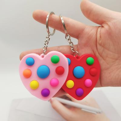 China New waterproof push sensory push up fidgety person toy heart shape sound he key chain mini silicone valentine heart the jump key chain for sale