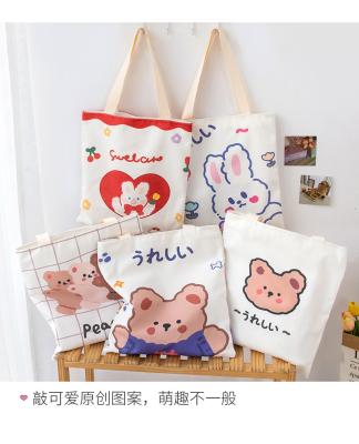 China Softly 2022 Fashions Mini School Student Cartoon Bear Charm Canvas Book Tote Shoulder Bag Canvas Shopping Handbag For Women Lady for sale