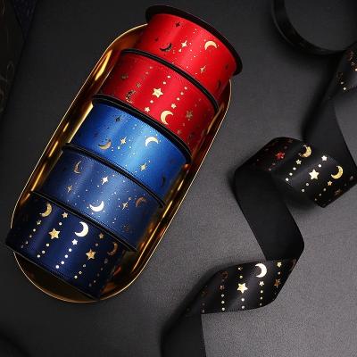 China Single face 9 meters roll up sale romantic star and moon gold foil hologram printing bundle ribbon for sale