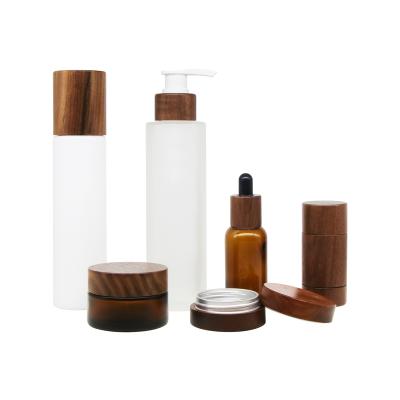 China Skin care ; cosmetic bamboo wooden cosmetic packaging wooden cosmetic package cap glass bottles with wooden lid for cosmetics for sale