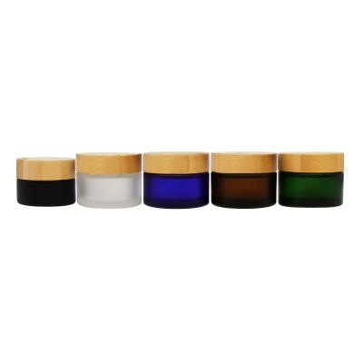 China Household green empty glass cream jar with cap glass bamboo jar with bamboo lid bamboo top cosmetic jar for sale