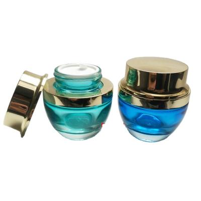 China 50ml High End Personal Care Glass Jar Colored Cream Bottle , Gold And Silver Lid For Skin Care for sale