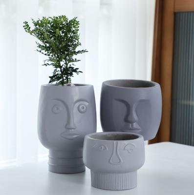 China Art Decor Differing Size Concrete Home Decorate Pot Face Design Flower Cement Planter Pot for sale