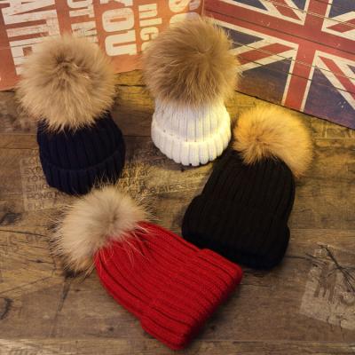 China JOINT Winter Products Wholesale Winter Hats Thick Faux Fur Pompom Knitted Beanie Hat for sale