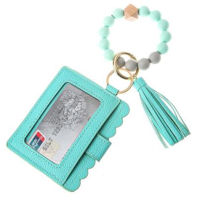 China Daily Life Wooden Silicone Beaded Wristband Bracelets Keychains Card Holders Wallets Leather Tassel Keychains For Women Fashion Accessories for sale