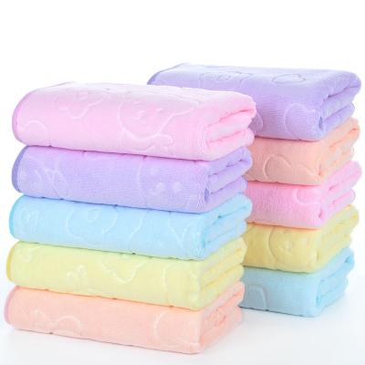 China Compressed wholesale cartoon embossed edging 400g 35*75cm towel quick-drying absorbent face towel for sale