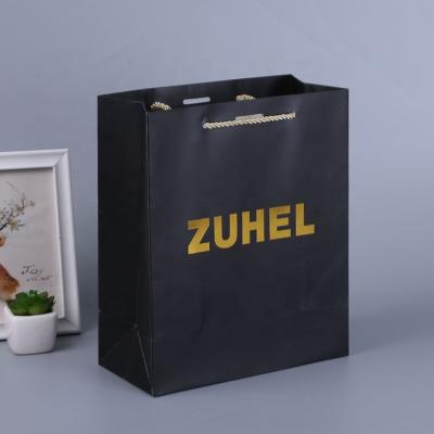 China Recyclable Customized Black Hot Stamping Paper Packaging Bag Can Be Printed Gold Foil LOGO Pattern Packaging Paper Bag for sale