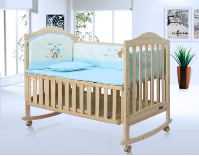 China Solid Wood Baby Swing Crib Play Wooden Crib Baby Bed with Wheels for sale