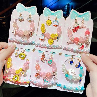 China Fan Cute Cute Princess Kids Cartoon Colorful Beaded Charm Bracelet Bell Daisy Earrings And Bracelet Set For Student Jewelry for sale