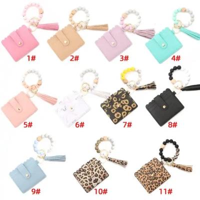 China Top Selling Waterproof Silicone Beads Bracelet With Tassel ID Credit Card Holder Ladies Key Chain Wallet Mini Clutch Bag for sale