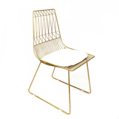 China Creative Hollow Backrest Convertible Wrought Iron Chair Simple Gold Metal Dining Chair for sale