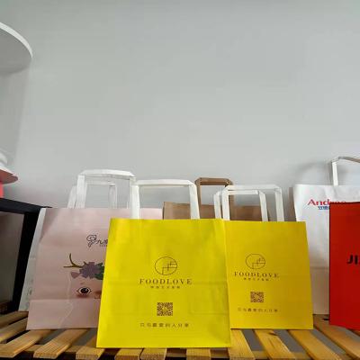 China Factory Cheapest Yellow Twisted Flat Handle Recyclable Printed Logo Craft Kraft Shopping Paper Bag for sale