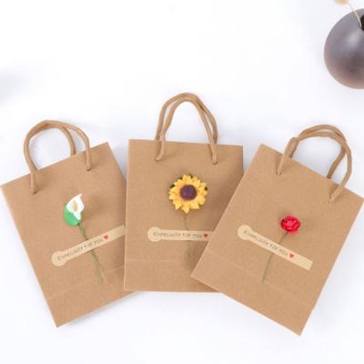 China Eco Friendly Recycled Materials Customs Shoe Clothes Kraft Paper Bags Flower Printing Custom Clothing Packaging Paper Shopping Bags With Logo for sale