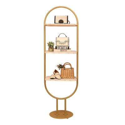 China Other Nordic women's clothing store floor creative single gold shelf type clothing store Zhongdao window display rack shoe bag rack for sale