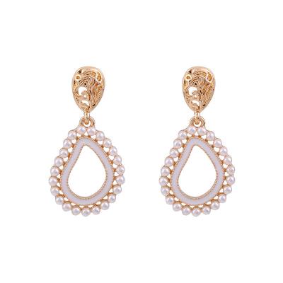 China Spring And Summer S925 Silver Needle Non Allergic Retro Palace Earrings Female Hollow Pearl Earrings for sale