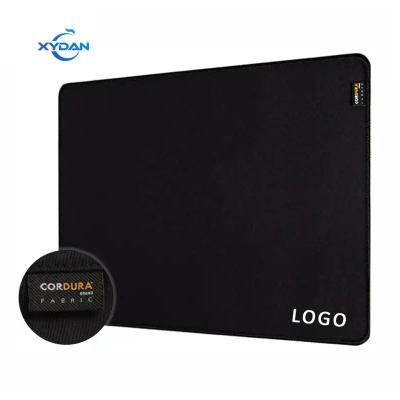 China 100% Eco-friendly Cordura Fabric Mouse Pad with Woven Label and Waterproof Desk Mat for sale